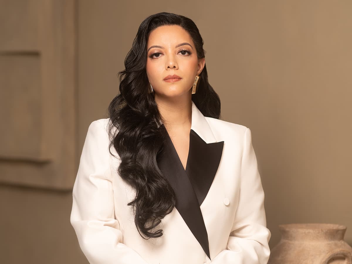 Oriyé founder Priscilla Laclé wearing a white blazer with black lapels